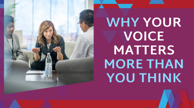 Business Meeting Scene With Woman In Dark Blazer Speaking Expressively To Colleagues In Modern Office With Large Windows, Accompanied By Purple And Blue Geometric Background Design And Text "Why Your Voice Matters More Than You Think"