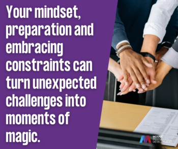 Leadership quote about mindset preparation and constraints turning challenges into magic with team hands stacked together