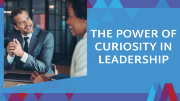 Blog feature image with bold white text on a blue geometric background reading "The Power of Curiosity in Leadership" beside a photo of two colleagues smiling and engaged in conversation at a meeting table.