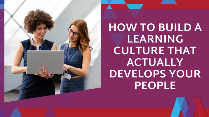 Two Professional Women Looking At A Laptop Together, With Text Overlay Reading "How To Build A Learning Culture That Actually Develops Your People" On A Purple Background With Mosaic People Development Brand Colours.