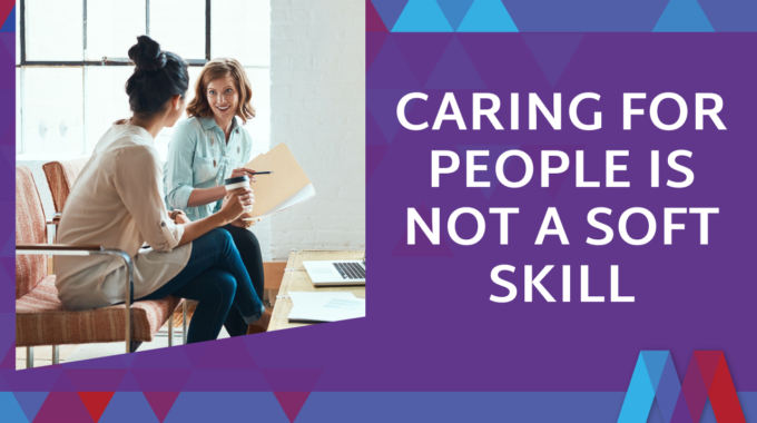 Purple And Blue Graphic With The Title 'Caring For People Is Not A Soft Skill' Next To A Photo Of Two Women Having A Conversation While Seated, One Holding A Coffee Cup And Papers, With A Laptop On A Table Nearby, Mosaic People Development Branding In The Corner.