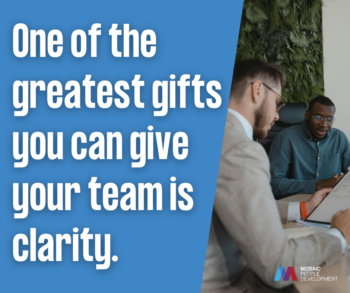 Pull quote graphic reading 'One of the greatest gifts you can give your team is clarity' beside a photo of two male colleagues reviewing a document together in an office, with the Mosaic People Development logo.