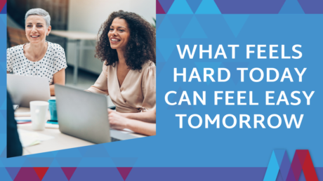 Two Smiling Businesswomen Sitting At A Table With Laptops And Coffee Mugs, With Text Reading 'What Feels Hard Today Can Feel Easy Tomorrow' On A Blue Background With Mosaic People Development's Geometric Triangle Design.